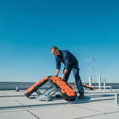 Professional installing Big Foot accessories on a rooftop
