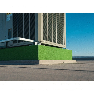 Close-up of a Big Foot anti-vibration pad supporting an HVAC unit on a rooftop